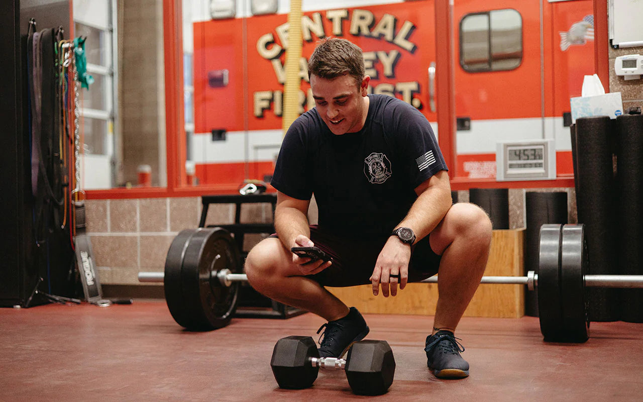 firefighter on phone working out